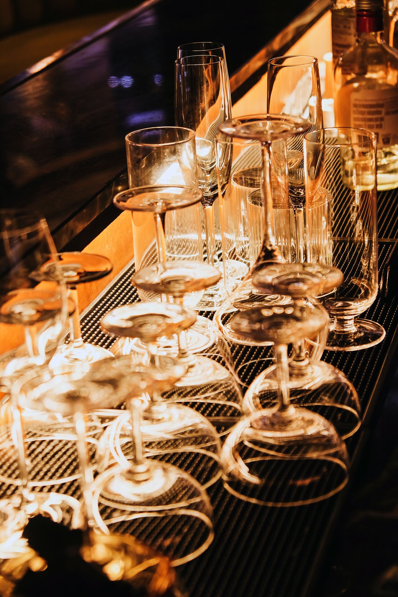 Champagne and wine glasses lined up on the bar at Andy's