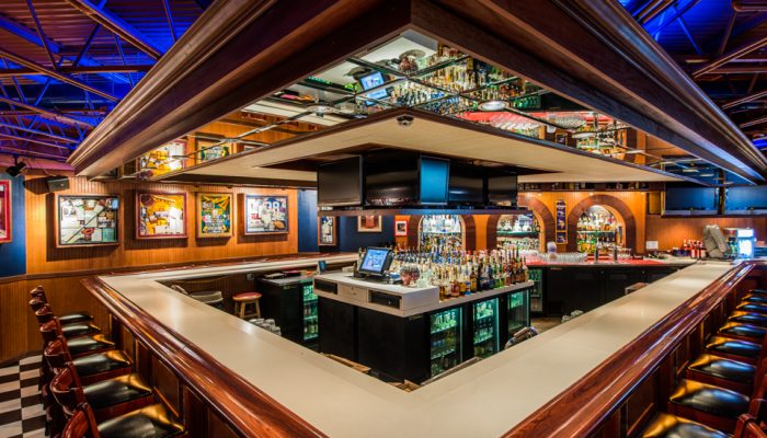 The bar at Andy's beneath a wall of HD TVs and the big screen